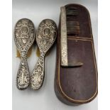 A pair of good quality silver backed hairbrushes and a tortoiseshell and silver comb within a