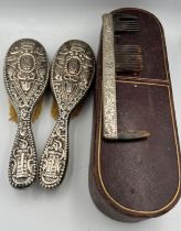 A pair of good quality silver backed hairbrushes and a tortoiseshell and silver comb within a