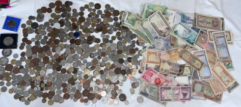 A large collection of coins and notes, mostly foreign to include India, Singapore, Pakistan,
