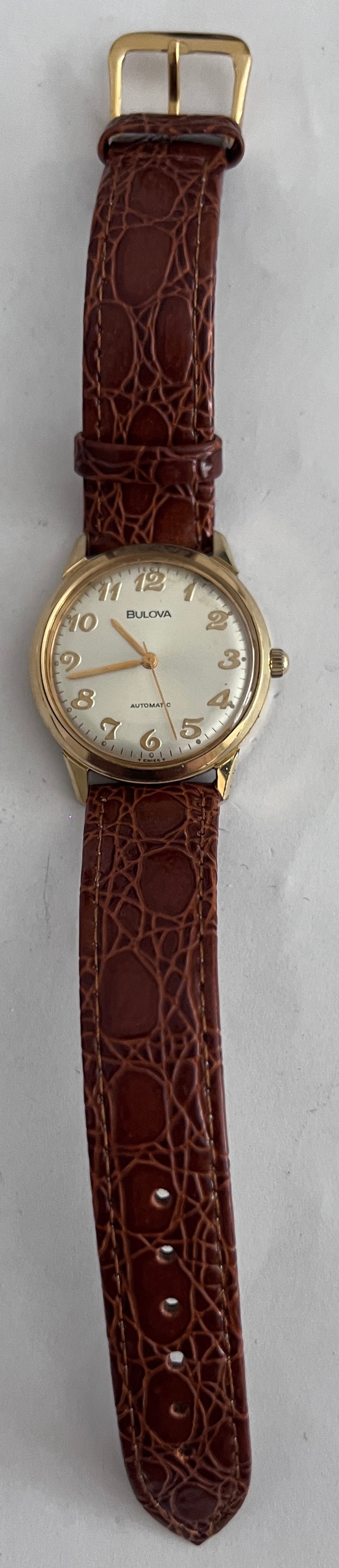 A 1974 vintage automatic Bulova wristwatch, gold plated on brown leather strap with silver face. - Bild 2 aus 5