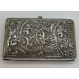 A Chinese silver cigarette case with repoussé decoration, a fight scene to one side, dragon to the