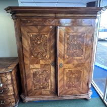 An 18thC Austrian inlaid two door wardrobe on bun feet. Dated 1727 to the top. 202cm h x 57cm d x