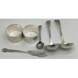 Silver to include a pair of napkin rings, Birmingham 1924, a pair of ladles Sheffield 1910, butter