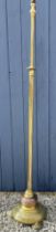 A heavy brass and copper standard lamp with circular base on 3 brass feet. 154cm h to top of