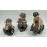 Three Royal Copenhagen figures of fawns, one fighting a bear, 648, one with snake 1742 and one