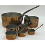 Set of 7 Copper Pans, the larger two with cast iron handles,the smaller ones with brass handles