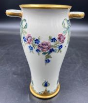 A William Moorcroft for Macintyre Burslem vase with floral garlands and rosettes. 19cms. Stamped