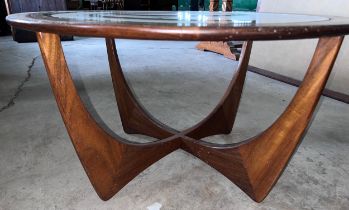 A mid 20thC G Plan circular rosewood table with glass top. 84cm d x 46cm h.