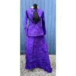 A Victorian taffeta purple skirt and bodice with hooks and bows to the front and lace collar.