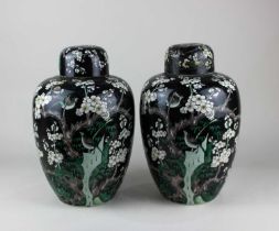 A pair of Chinese famille noire ginger jars and covers, decorated with birds amongst blossom 34cm