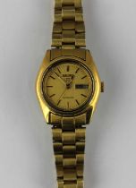 A Seiko 5 automatic gilt metal and steel ladies bracelet watch the signed gilt dial with day and