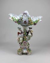 A Sitzendorf porcelain comport centrepiece, floral encrusted, with shaped oval dish, pair of figures
