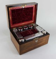 A Victorian rosewood dressing table box the fitted interior with glass and silver plated jars,