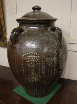 A large ceramic pot and cover, with four handles and decorated with fish, height 67cm