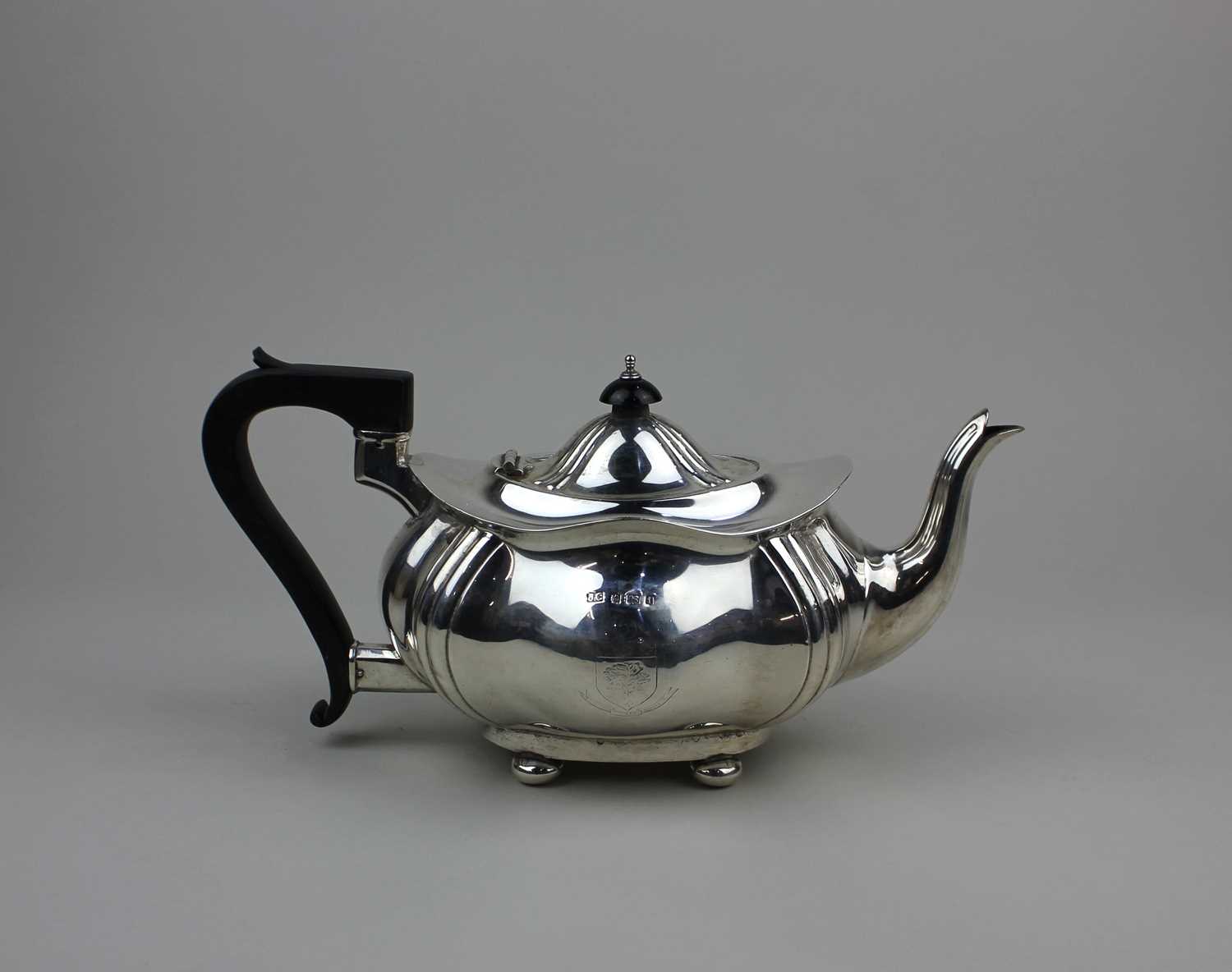 An Edward VII tea pot of oval form with fluted corners, a hinged dome ...