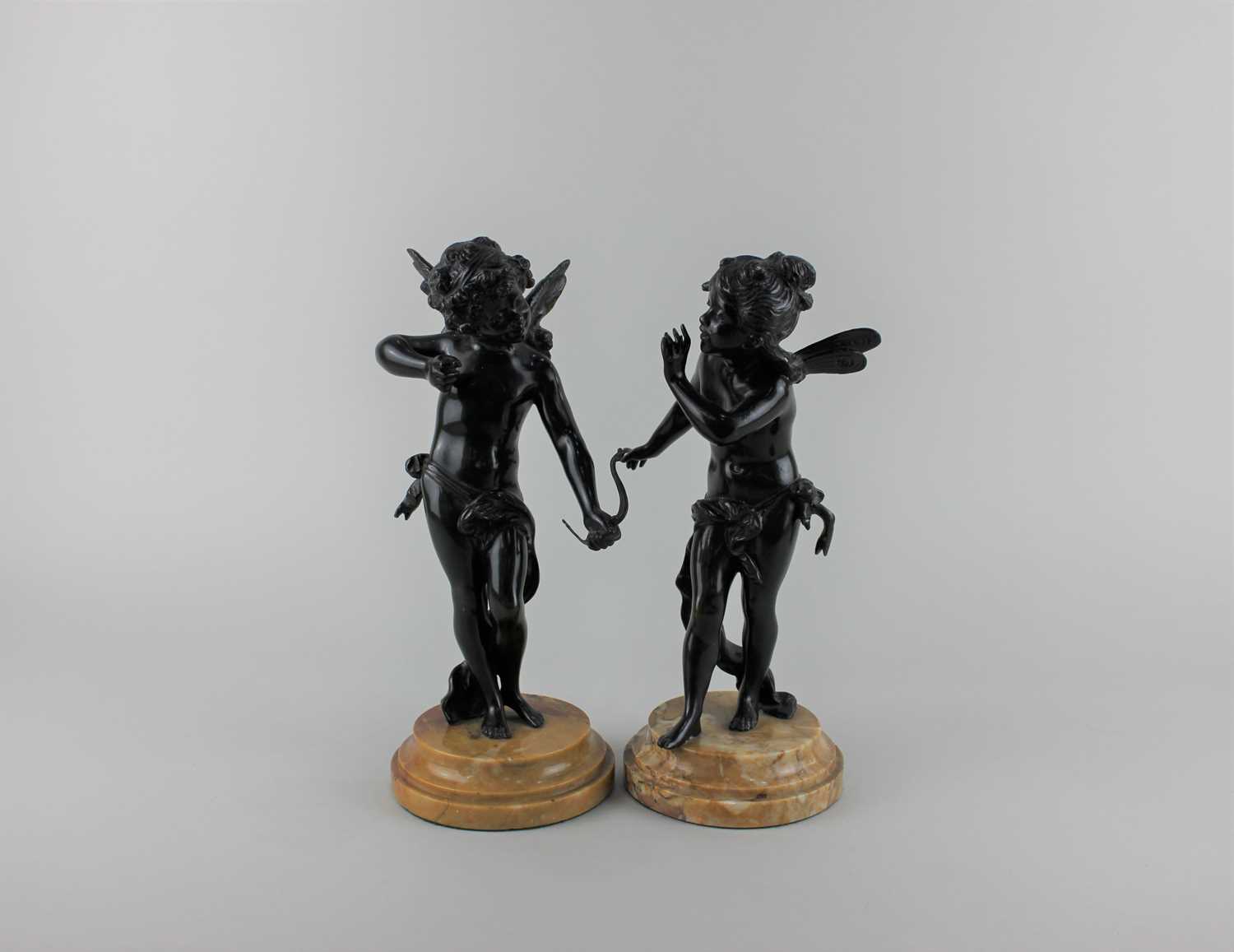 A pair of bronze figures of Cupid and Psyche on circular hardstone bases tallest 27cm high including