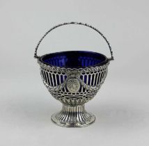 A George III silver basket neo-classical form with cast laurel swags, pierced sides and engraved