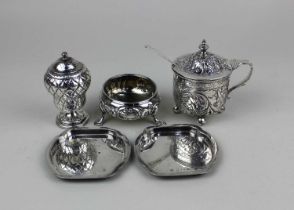 A Victorian silver mustard pot with embossed floral decoration, monogram engraved cartouche and blue