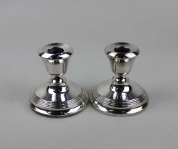 A pair of George VI silver dwarf candlesticks 8cm high (loaded bases)