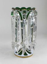 A green glass table lustre, white overlaid with gilt embellishments, with clear glass lustre drops