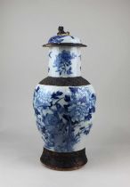 A Chinese blue and white baluster vase and cover decorated with birds amongst flowers, character