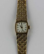 An Omega 9ct gold ladies bracelet wristwatch the signed curved square silvered dial with black baton