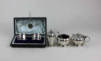 An Elizabeth II silver three piece cruet set of melon type form and two spoons, maker Adie