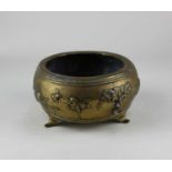 A Chinese brass bowl raised on three feet, Xuande type mark to base 15cm diameter