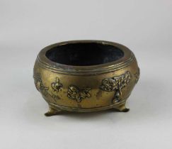 A Chinese brass bowl raised on three feet, Xuande type mark to base 15cm diameter