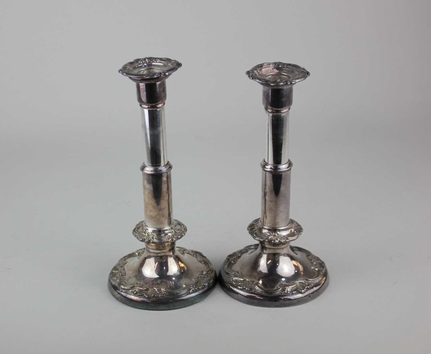 A pair of silver plated candlesticks possibly Irish with removable drip trays and single
