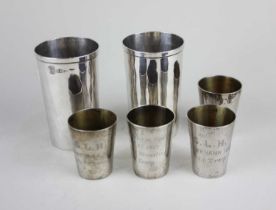 Two sterling silver beakers, weight 3.8oz together with four Eastern white metal tots with