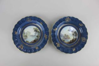 A pair of Royal Worcester cabinet plates with a view of Loch an Eilan and Ragland Castle on a gilded