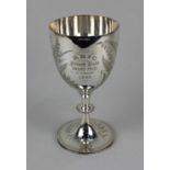 A silver plated trophy chalice engraved 'RBYC Private Budd Sword Prize Troop 1885' amongst ferns,