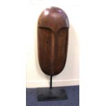 20th century school, carved wood sculpture of a head, unsigned, on metal stand, 115cm high including