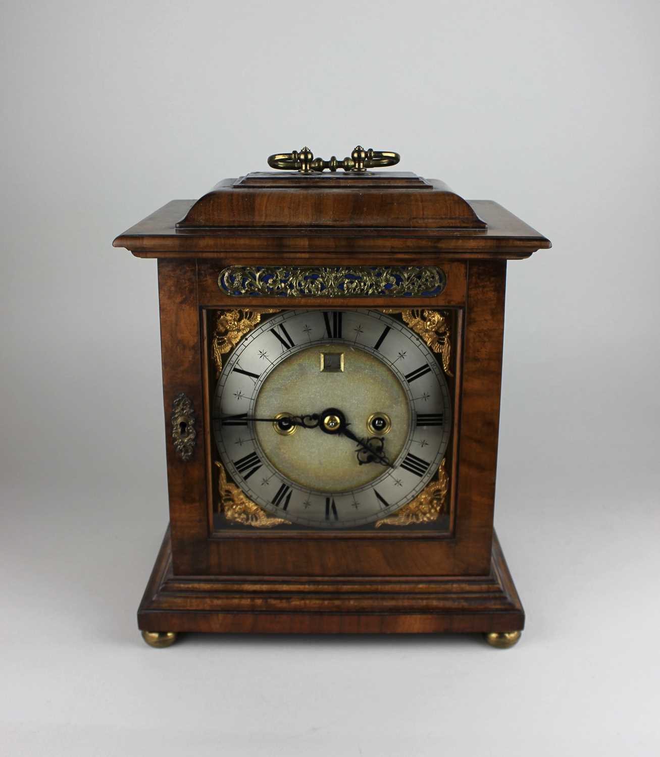 A George III style walnut bracket clock the six and a half inch dial with silvered chapter ring
