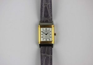 A Jaeger le Coultre Reverso steel and 18ct gold rectangular cased folding wristwatch, the signed