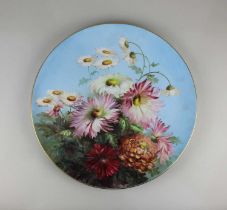 A Royal Worcester porcelain charger painted by J E Sadler, decorated with chrysanthemum on blue