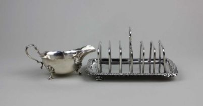 A Victorian silver toast rack six divisions on scroll framed rectangular base, engraved initials (