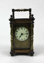 A brass carriage clock with white enamel dial, arabic numerals with floral scroll face, ht 15cm