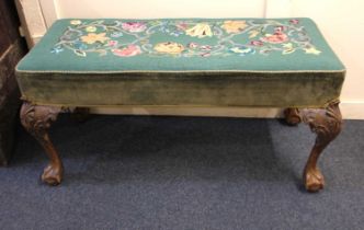 A green and floral tapestry upholstered window seat on carved cabriole legs with claw and ball feet,