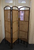 A three-fold room screen with rattan inset panels each panel 165cm by 47cm (a/f)