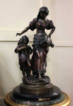 After Moreau, a patinated bronzed figure group of woman and child, on circular marble base 61cm