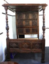A carved oak four poster double bed with carved panel ceiling and pine slats approx 144cm wide,