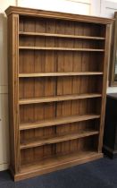 A large pine bookcase with six adjustable shelves on plinth base width 138cm, height 196cm