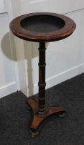 A Victorian rosewood jardiniere pot plant stand with circular dished top on turned baluster stem,