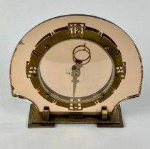 A c.1930's British Art Deco mantle clock the domed peach glass case with copper and brass mounts,