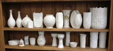 A group of Kaiser porcelain white matte vases with relief moulded floral designs, with other vases