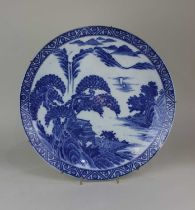 A Chinese blue and white porcelain charger decorated with figures in a landscape 37cm