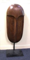 20th century school, carved wood sculpture of a head, unsigned, on metal stand, 115cm high including