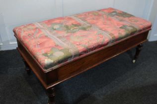 A Victorian upholstered window box seat rectangular rising top on turned legs and castors, 110cm